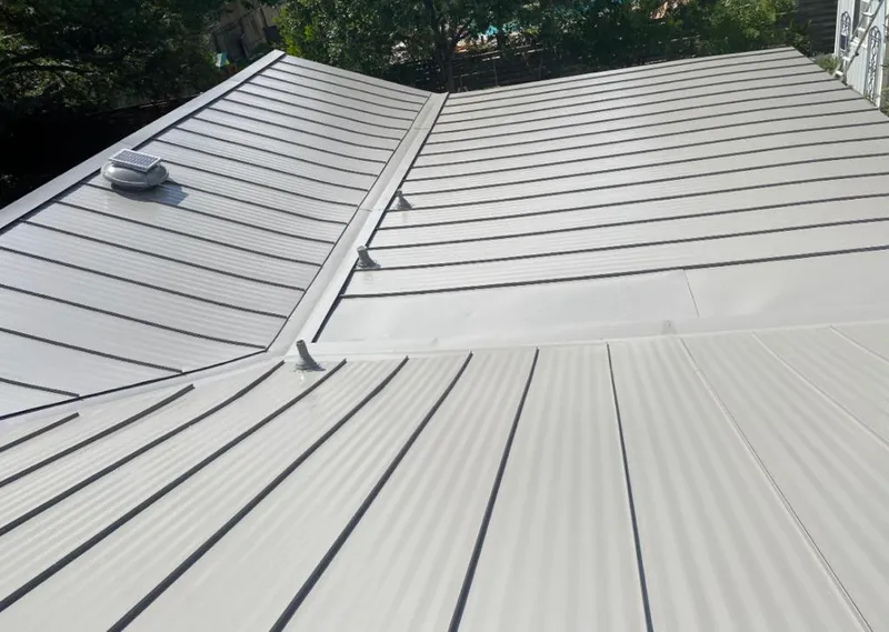 Solar attic fan installed on a metal roof for Roof Ventilation in Bettendorf